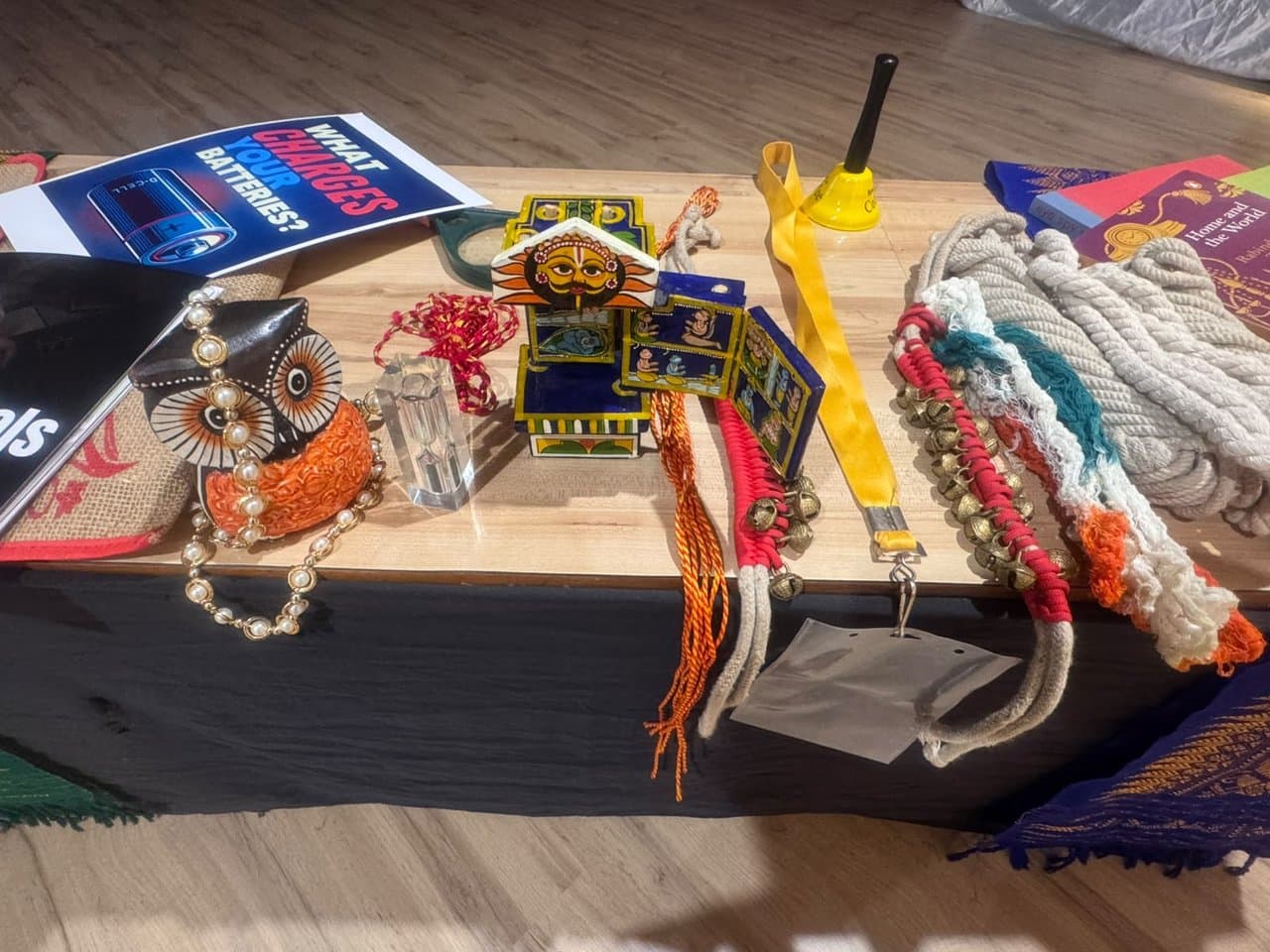 Storytelling props table with Kavad, owl figurine, ghungroo, and ropes