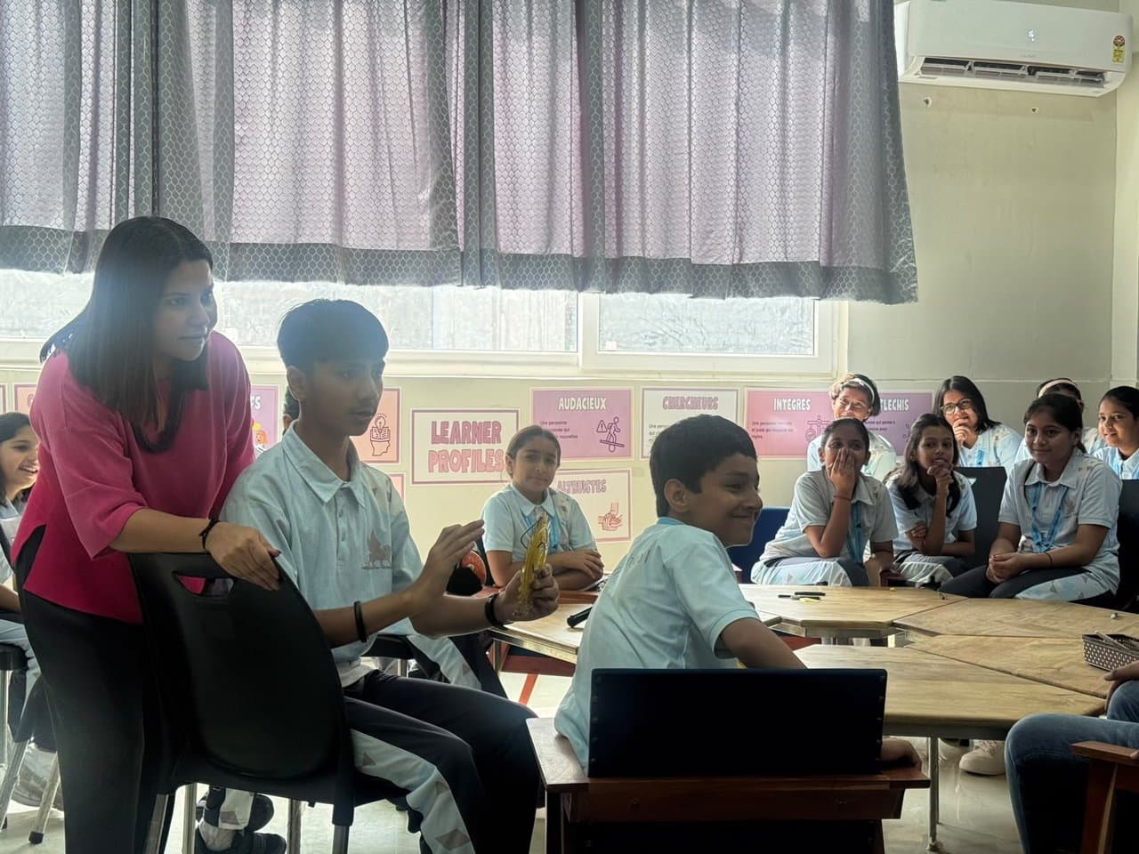 Classroom storytelling session with students and IB learner profile posters