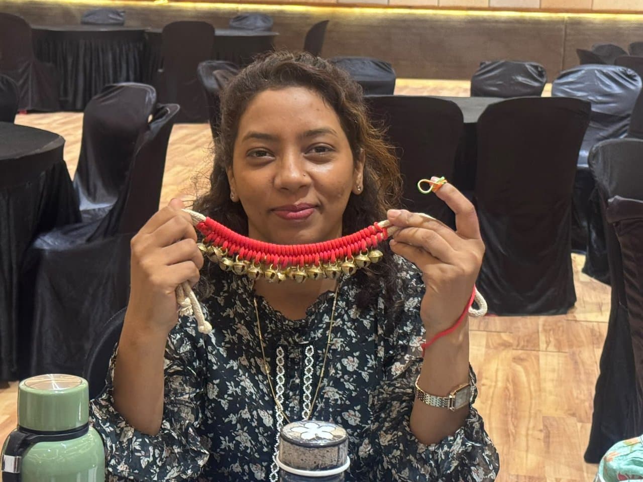 Educator holding a handmade ghungroo necklace prop during a storytelling workshop