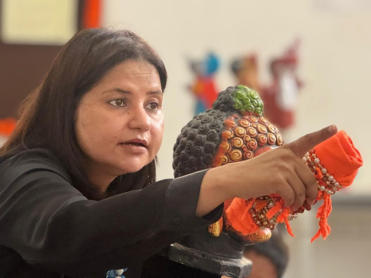 Tripti Pareek mid-speech with storytelling props